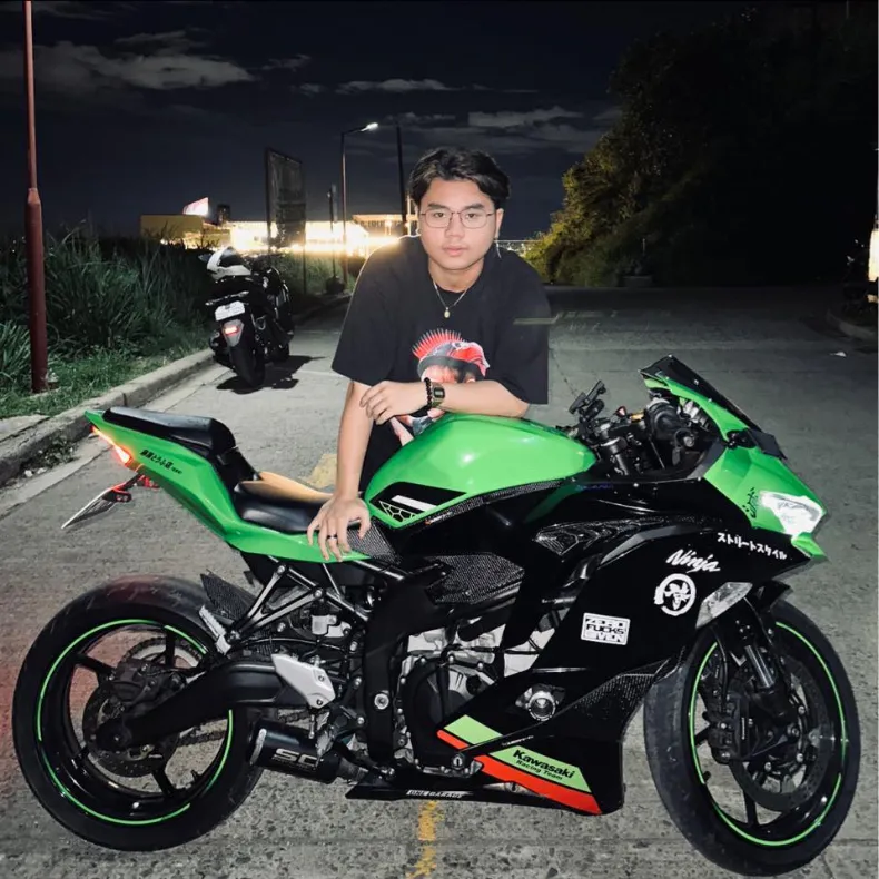 Prince Orale with his Kawasaki, helmet off